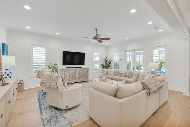 living room featuring french doors, light hardwood / wood-style floors, ornamental molding, and ceiling fan