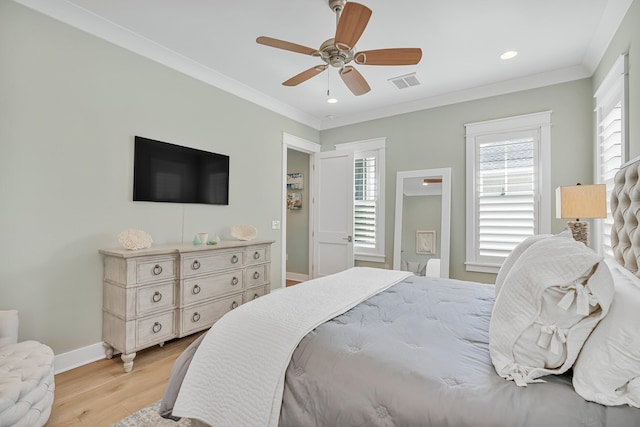 bedroom with light hardwood / wood-style flooring, ornamental molding, and ceiling fan