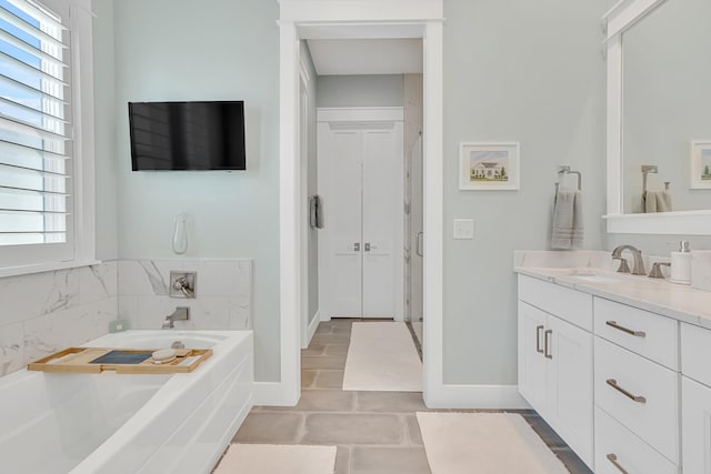 bathroom featuring vanity, a tub, and tile patterned floors