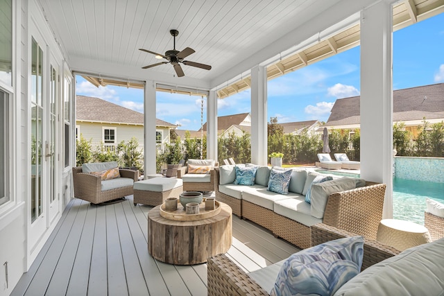 sunroom / solarium featuring ceiling fan