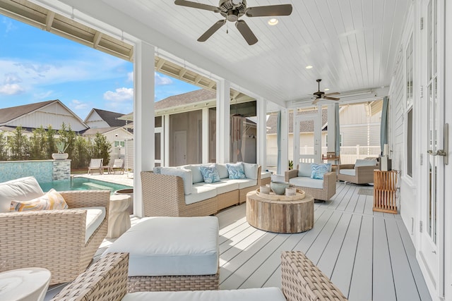 sunroom featuring ceiling fan and wooden ceiling