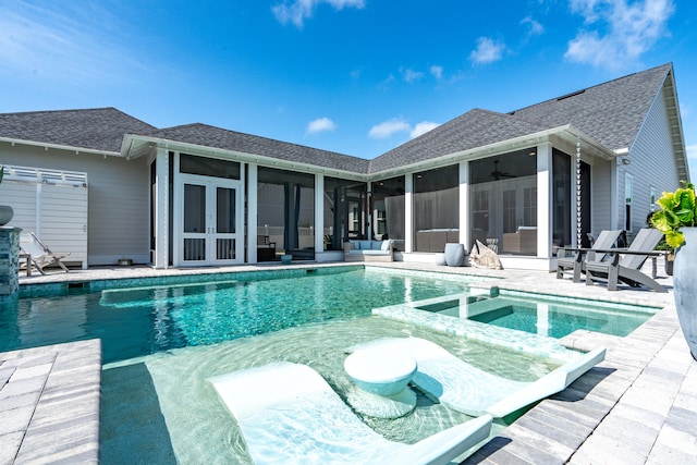 view of pool with a sunroom and a patio area