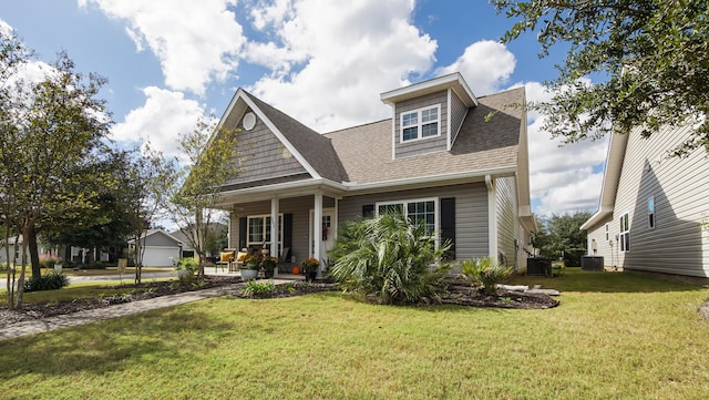 view of front of house featuring covered porch, a front yard, and cooling unit