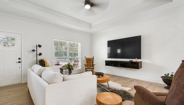 living room with ceiling fan, plenty of natural light, and light hardwood / wood-style flooring