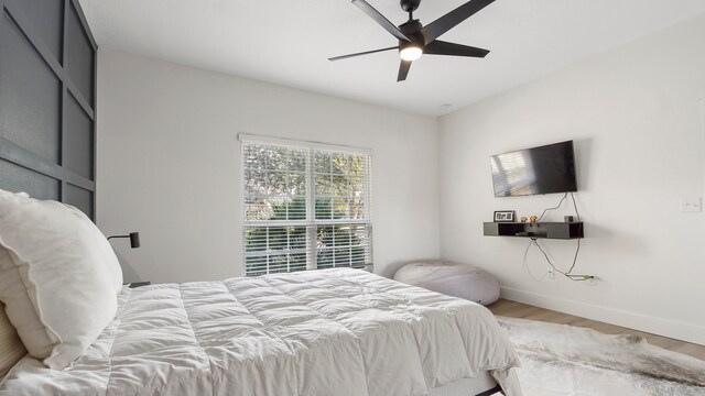 bedroom with hardwood / wood-style flooring and ceiling fan