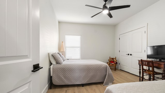 bedroom with ceiling fan and light hardwood / wood-style flooring