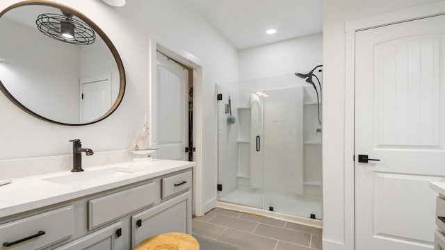 bathroom featuring vanity, an enclosed shower, and tile patterned flooring