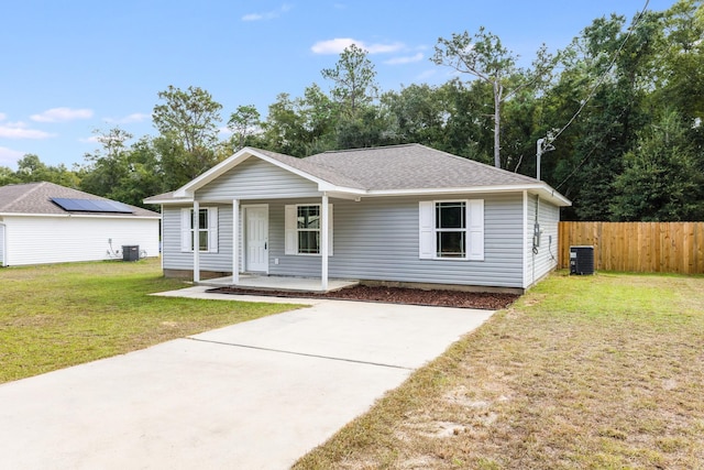 view of front of property featuring covered porch, a front yard, and cooling unit