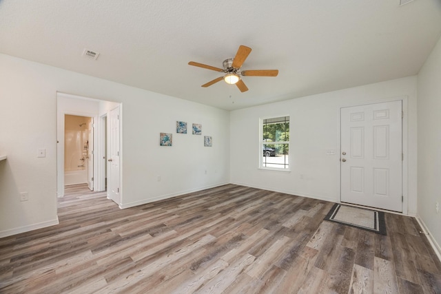 spare room with hardwood / wood-style floors and ceiling fan