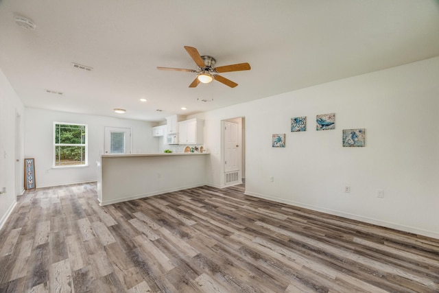 unfurnished living room featuring wood-type flooring and ceiling fan