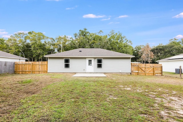 back of property with a patio area and a lawn