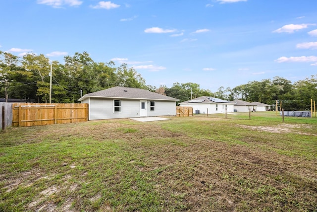 rear view of property with a yard