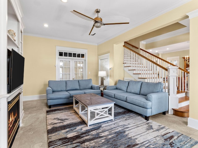 living room with ornamental molding and ceiling fan