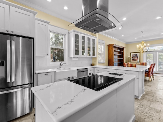 kitchen featuring a wealth of natural light, a center island, kitchen peninsula, and stainless steel appliances