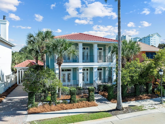 mediterranean / spanish-style home with a balcony and covered porch