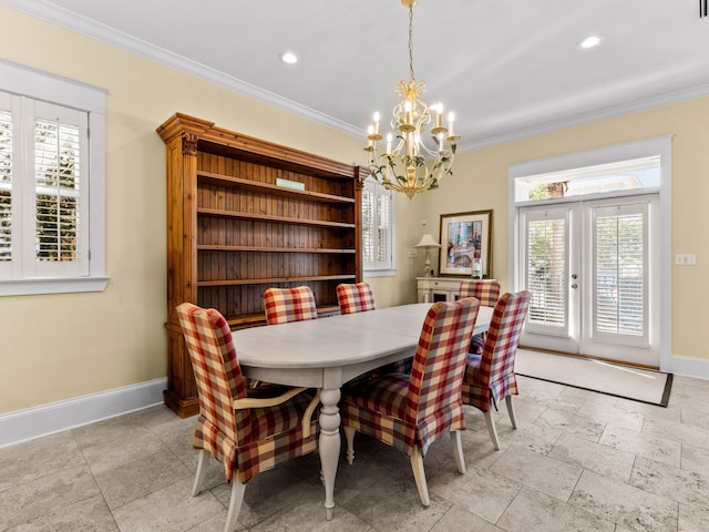 dining area with crown molding, a chandelier, and a wealth of natural light