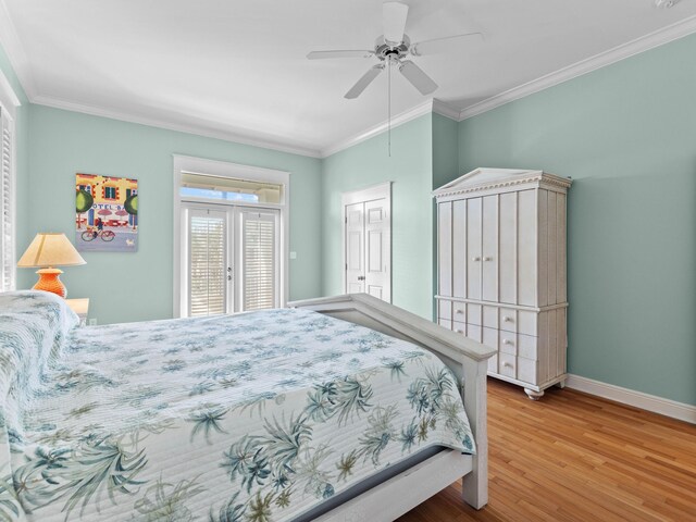 bedroom featuring french doors, hardwood / wood-style floors, a closet, ceiling fan, and ornamental molding