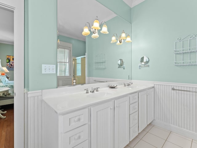 bathroom featuring vanity, a shower with door, ornamental molding, and tile patterned flooring