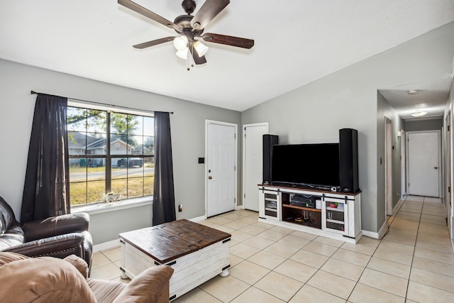 living room with lofted ceiling, light tile patterned flooring, and ceiling fan