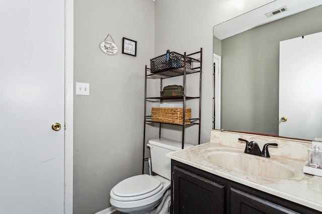 bathroom featuring toilet and vanity