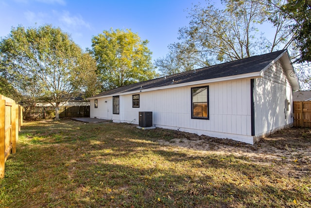 back of house with a patio, central AC, and a lawn