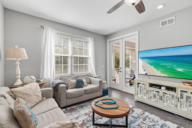 tiled living room with french doors and ceiling fan