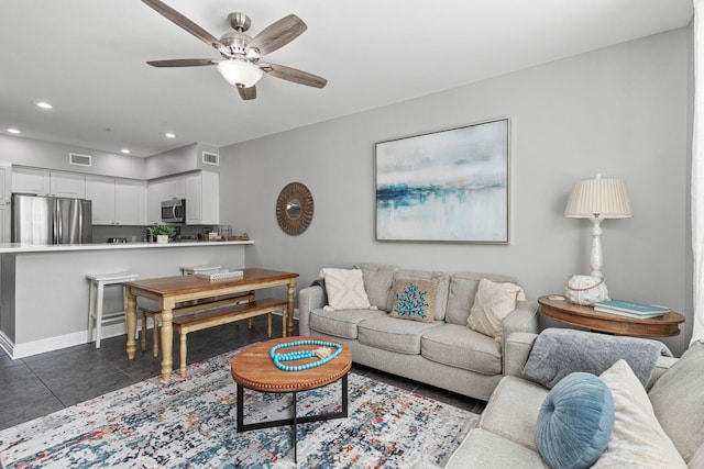 tiled living room with baseboards, a ceiling fan, visible vents, and recessed lighting