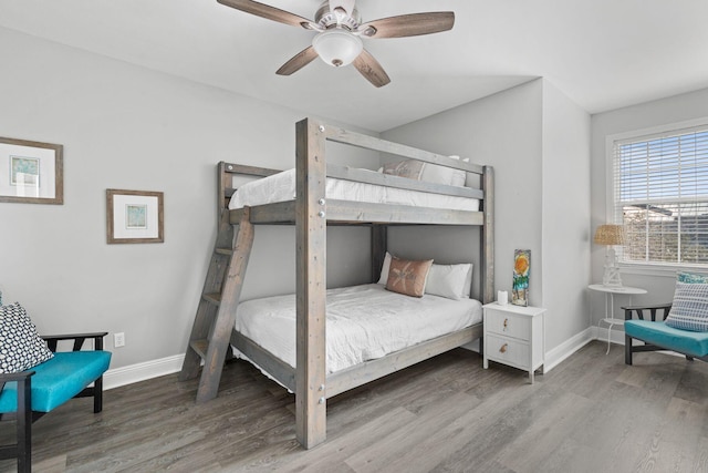 bedroom featuring ceiling fan, wood finished floors, and baseboards