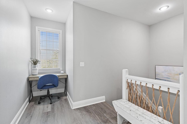 office space featuring baseboards and wood finished floors