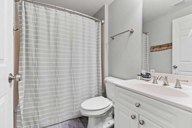 bathroom featuring toilet, visible vents, and vanity