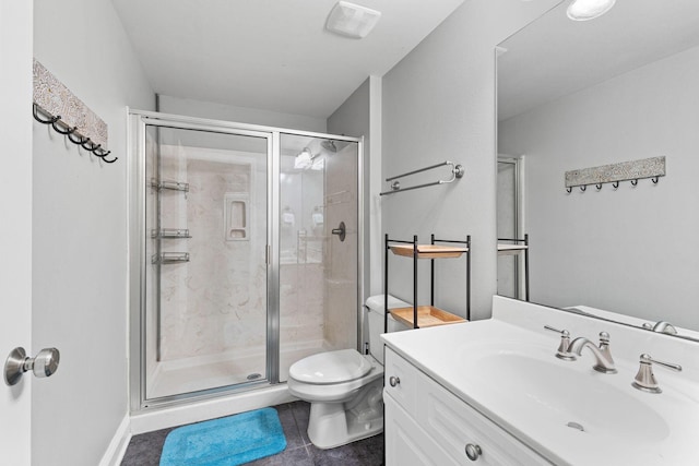 bathroom featuring a stall shower, vanity, toilet, and tile patterned floors