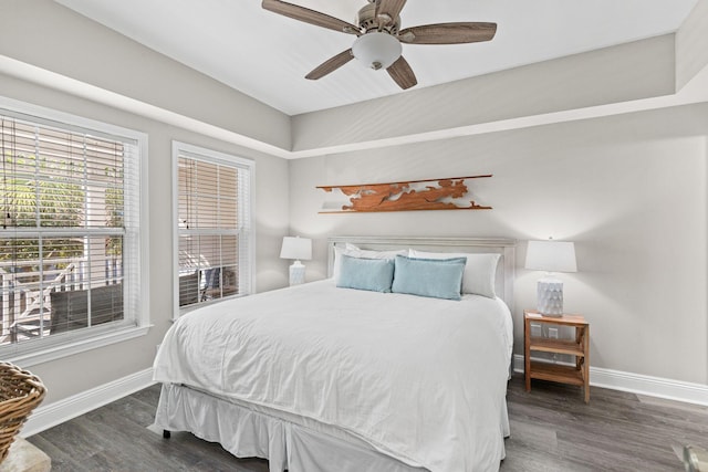 bedroom with wood finished floors, a ceiling fan, and baseboards