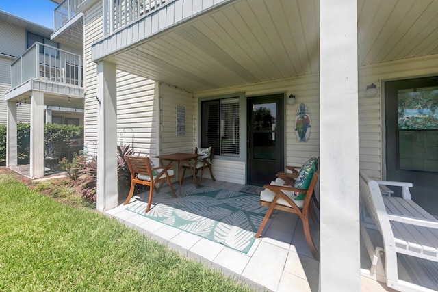 view of patio featuring a balcony