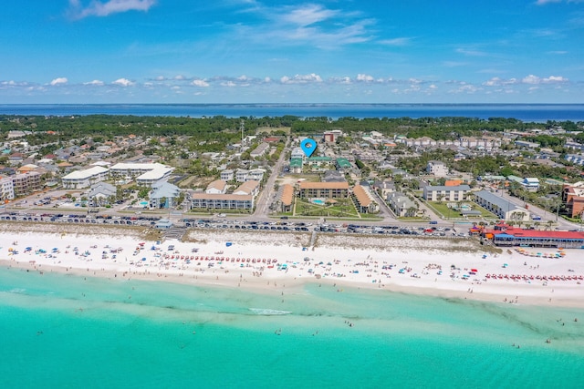 aerial view with a water view and a beach view