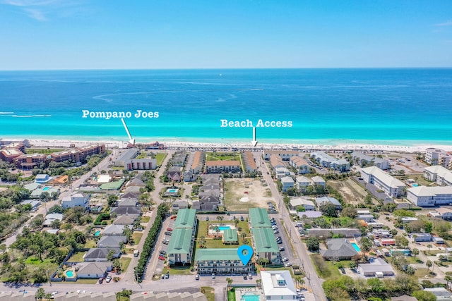 birds eye view of property with a water view and a beach view