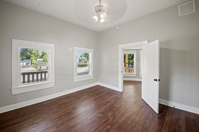 unfurnished room with ceiling fan and dark hardwood / wood-style floors