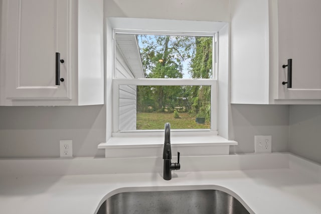 interior details with sink and white cabinets