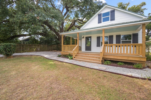 view of front of house with a front yard and a porch