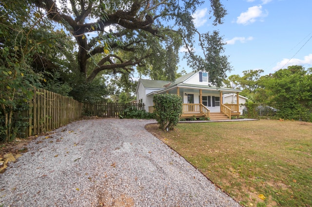 view of front of property with covered porch and a front yard