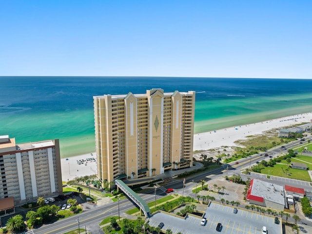 drone / aerial view featuring a water view and a view of the beach