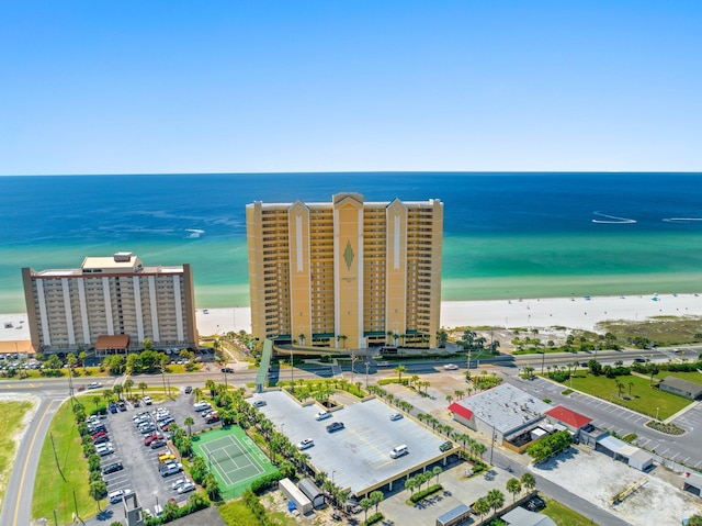 birds eye view of property with a water view and a beach view