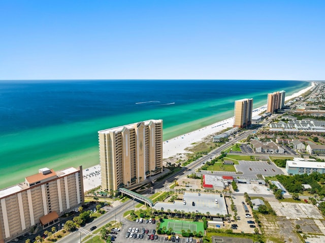 drone / aerial view with a water view and a beach view