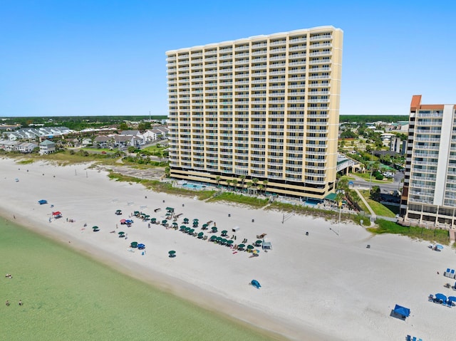 drone / aerial view with a water view and a beach view