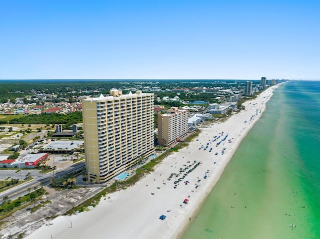 birds eye view of property with a water view and a beach view