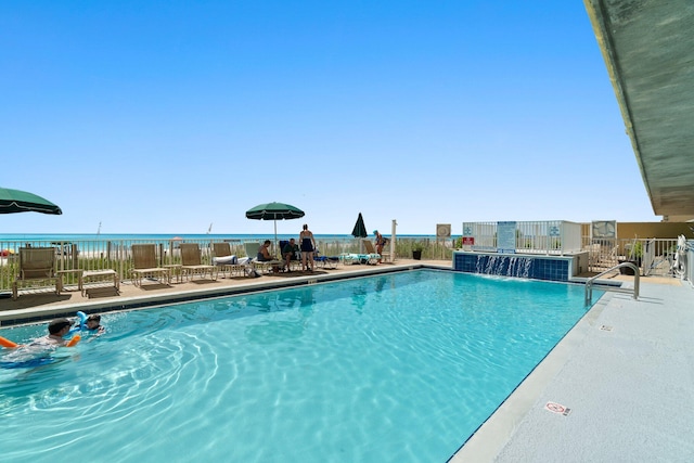 view of pool featuring a water view, a patio, and pool water feature