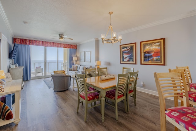 dining area with crown molding, a textured ceiling, dark hardwood / wood-style floors, and ceiling fan with notable chandelier