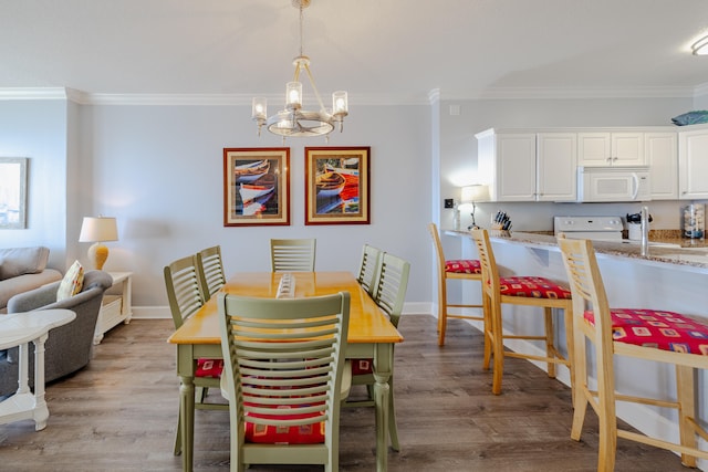 dining area featuring crown molding and light wood-type flooring