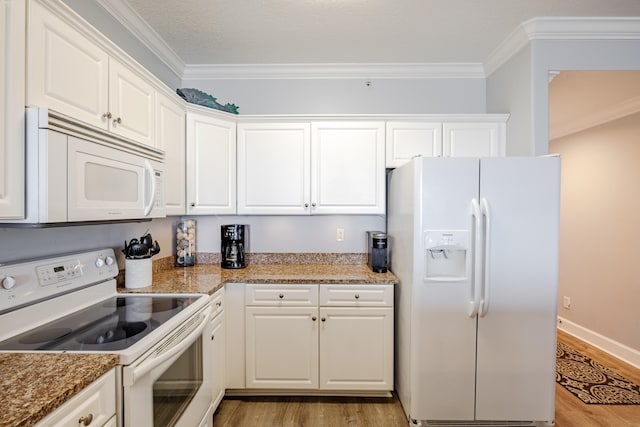 kitchen featuring white appliances, ornamental molding, light hardwood / wood-style flooring, and white cabinets