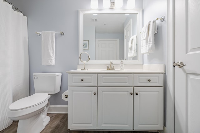 bathroom with vanity, toilet, and hardwood / wood-style floors