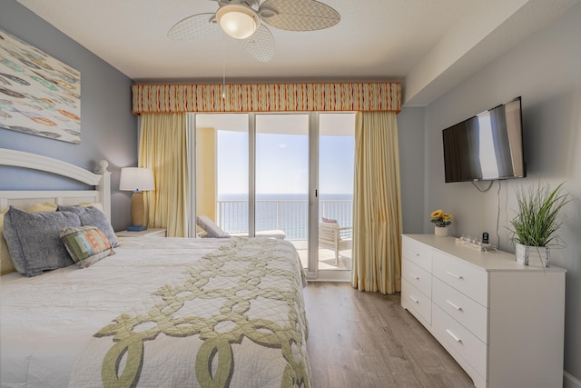 bedroom with access to exterior, light wood-type flooring, and ceiling fan